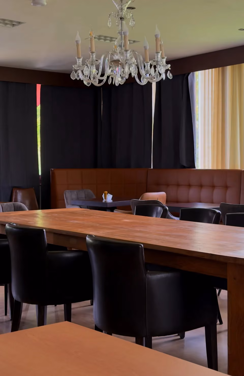Long wooden table with leather chairs